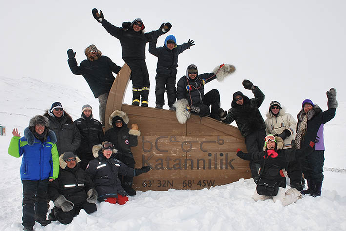Group picture of people in snow at land camp